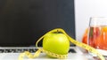 Close up green apple and tape measure. Healthy snack for diet planning for working in office Royalty Free Stock Photo