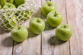 Close-up green apples and cotton string mesh bag on a wooden table. Copy space Royalty Free Stock Photo