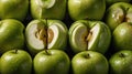 A close-up of green apples, some whole and one sliced in half, showcasing their interior Royalty Free Stock Photo