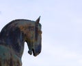 Close up of horse head sculpture. Bronze horse head against blue sky. Royalty Free Stock Photo