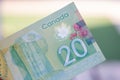 Close up of green Canadian Twenty 20 dollar bill with blurred defocused background. Macrophotography