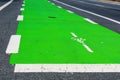 Close up. Green colored bike lane surfacing communicates to road users that a portion of the roadway has been set aside for Royalty Free Stock Photo