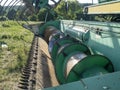 Close-up of a green combine harvester auger. Agricultural machinery