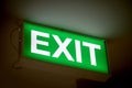 Close up Green Exit sign on door in the building