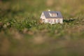 Close up of green grass field with model house Royalty Free Stock Photo