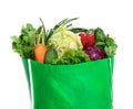 Close up a green grocery bag of mixed organic green vegetables o