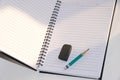 Close up Green Pencil and black eraser placed on a notebook Royalty Free Stock Photo