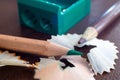 Close-up of a green pencil sharpened in a sharpener, with shavings of wood at the end Royalty Free Stock Photo