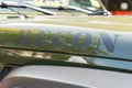 Close-up of a green pick-up truck parked in the lot among other vehicles in Manchester