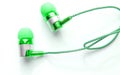 Close-up of green portable headphones for smart work online meetings and conference calls, devices for the phone