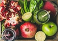 Close-up of green and purple fresh juices with fruits, vegetables