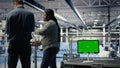 Close up of green screen tablet in front of data center engineers improving rigs Royalty Free Stock Photo