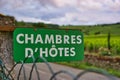 Close-up of a green sign with inscription "guest rooms" in countryside under cloudy sky Royalty Free Stock Photo