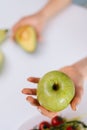 Close-up of green tasty apple in woman hand