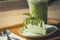 Close up green tea cake and matcha iced green tea on wooden salver.