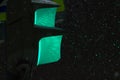 Close up of green traffic light during the snowfall in the evening Royalty Free Stock Photo