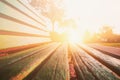 Close up of green wooden bench in urban park during sunset time. Royalty Free Stock Photo