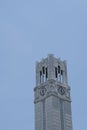 Close up grey Bell and clock tower up against blue clear sky. Royalty Free Stock Photo