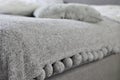 close up grey blanket with pompoms Royalty Free Stock Photo