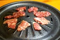 Close-up of grilled pork belly on Korean barbecue grill pan Royalty Free Stock Photo