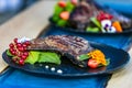 Close up grilled steak with fresh salad on a black plate Royalty Free Stock Photo