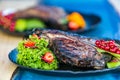 Close up grilled steak with fresh salad on a black plate Royalty Free Stock Photo
