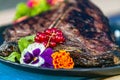 Close up grilled steak with fresh salad on a black plate Royalty Free Stock Photo