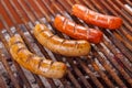 Close up of grilling sausages on barbecue grill. BBQ in the garden. Bavarian sausages Royalty Free Stock Photo