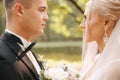 Close up of groom and bride. Portrait of newlyweds outside