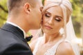 Close up of groom and bride. Portrait of newlyweds outside