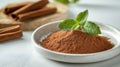 Close-up of ground cinnamon on white ceramic dish with fresh mint sprig, clean and minimalistic, emphasizing contrast Royalty Free Stock Photo
