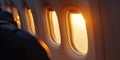 Close-up of a group of airplane windows against a sky of clouds. Airplane cabin. Generative AI Royalty Free Stock Photo