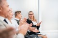 Close up. a group of business people applaud during a business seminar. Royalty Free Stock Photo