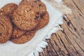 Close up of a group Chocolate chip cookies many stacked on apron sackcloth dark