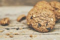 Close up of a group Chocolate chip cookies many stacked on dark old rustic wooden plank table