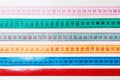 Close up of a group of colorful measure tapes lying in rows as a background. Diet concept on wooden background