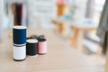 Close-up a group of colorful sewing threads on the table with blur designers or tailors table in the studio in the background. Royalty Free Stock Photo