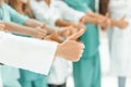 Close up. group of doctors showing thumbs up.