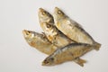 Close up of dried herrings against a white backgound.