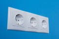 Close up - group of empty white electrical european outlet located on blue wall Royalty Free Stock Photo