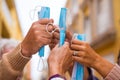 Close up of a group of four hands together holding a medical and surgical mask after winnig covid-19 and be free and can no wear