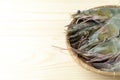 Close up group of fresh raw pacific white shrimp in bamboo bowl on wooden table Royalty Free Stock Photo