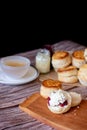 Close up group of fresh yummy tasty delicious Traditional British Scones and a cup of tea on wooden table