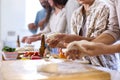 Close Up Of Group Of Friends At Home In Kitchen With Making Pizzas For Party Together Royalty Free Stock Photo