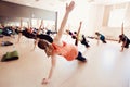 Close-up of a group of girls team engaged in fitness and stretching muscles in the gym.