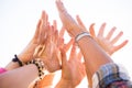 Close up of group of hands in the air with white background - happy and active people in teamwork cooperation concept - enjoying Royalty Free Stock Photo