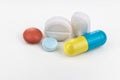 Close-up on group of medicine in capsule, caplet, tablet format on white background