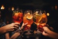 Close-up of a group of people clinking glasses with cocktails, Close up of group of people clinking glasses with cocktails in pub