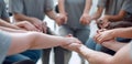 Close up. a group of people holding each other`s hands