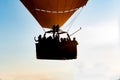 Close up of a group of people riding in a hot air balloon in the foreground and backlighting Royalty Free Stock Photo